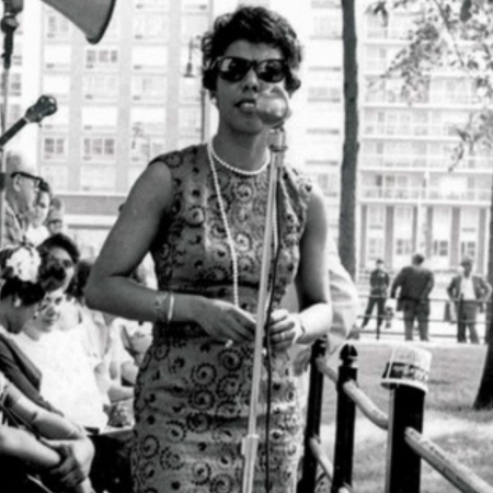 black and white photo of lorraine hansberry at a microphone